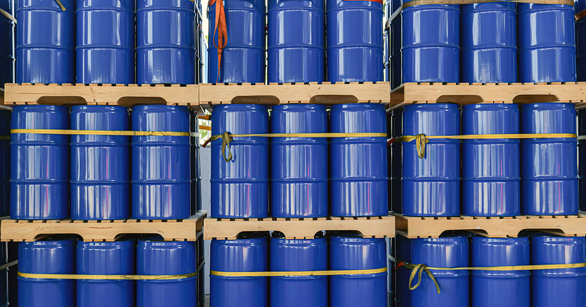 chemicals in barrels stacked in a warehouse