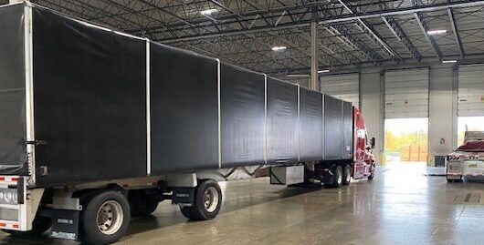 semi truck and trailer in a warehouse