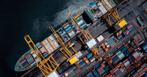 A ship loaded with cargo containers at a shipping port