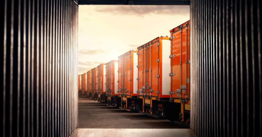 containerized cargo on trucks viewed from inside a shipping container