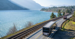 semi trucks and trailers driving down a roadway
