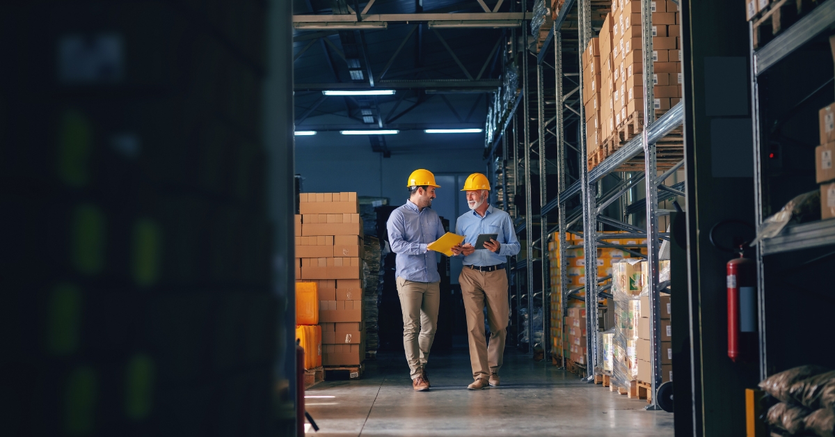 men in a warehouse talking