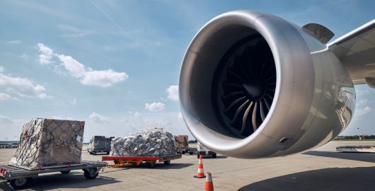 close up of an airplane propeller with freight in background