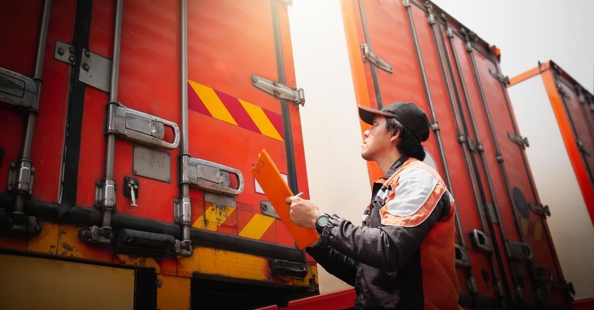 man performing safety checks on trucks