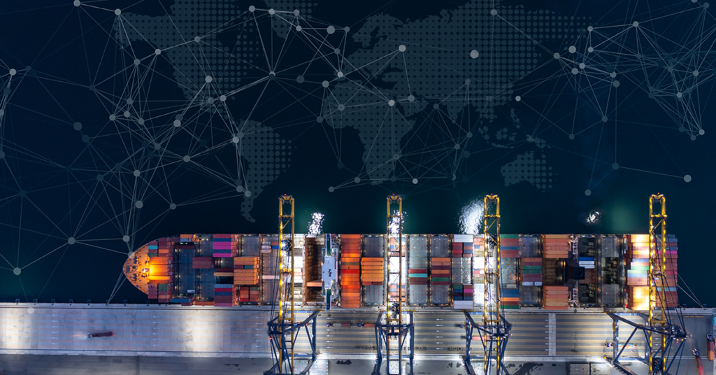 Aerial view at night of a container ship docked at a port with gantry cranes loading and unloading cargo, overlaid with a digital world map and a connected network graphic.