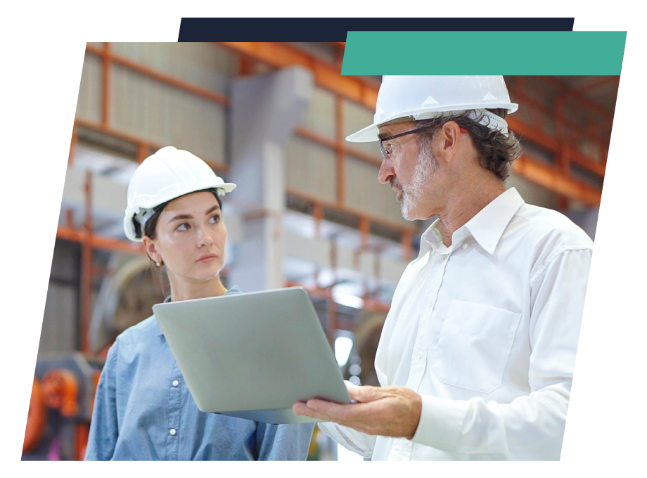 logistics leadership employees looking at a computer in a warehouse setting