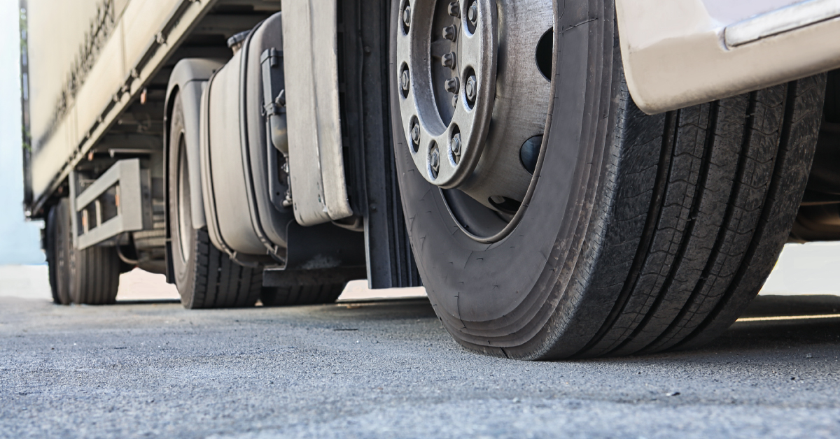ground view of the tires on a semi-truck and trailer