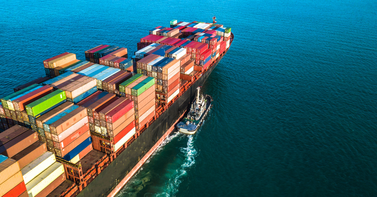 A ship in the ocean fully loaded with cargo shipping containers