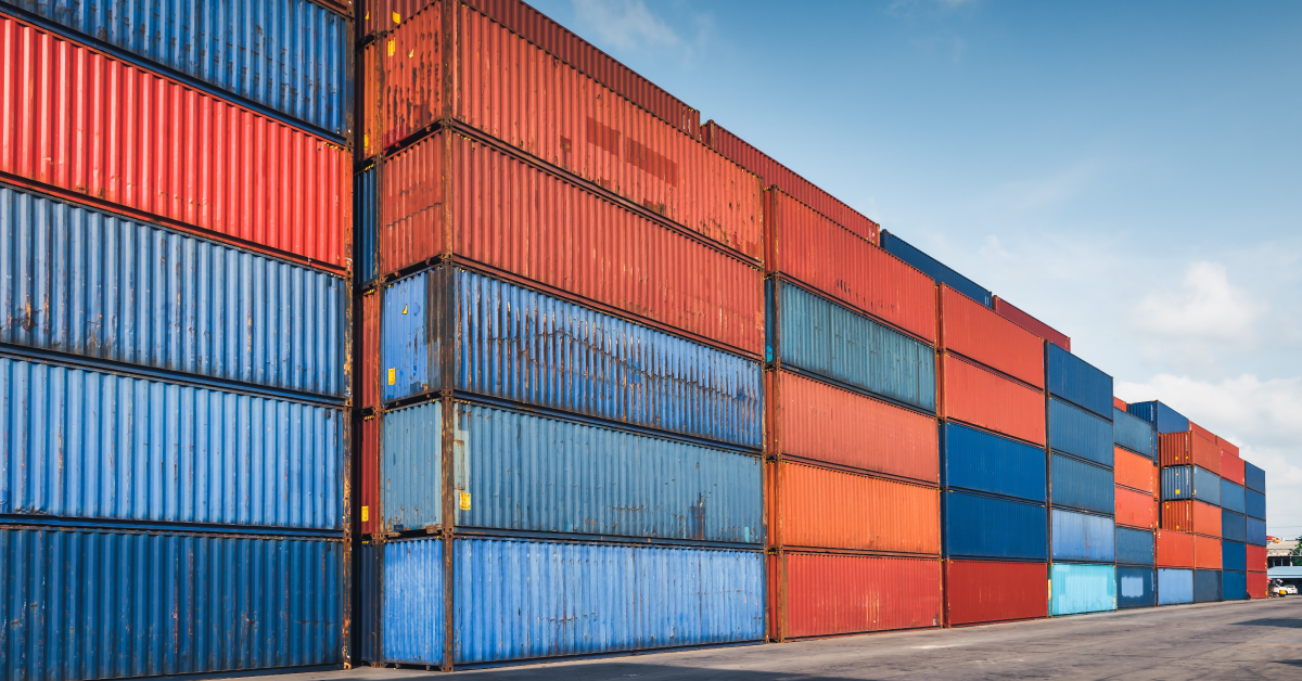 shipping containers in rows stacked up high