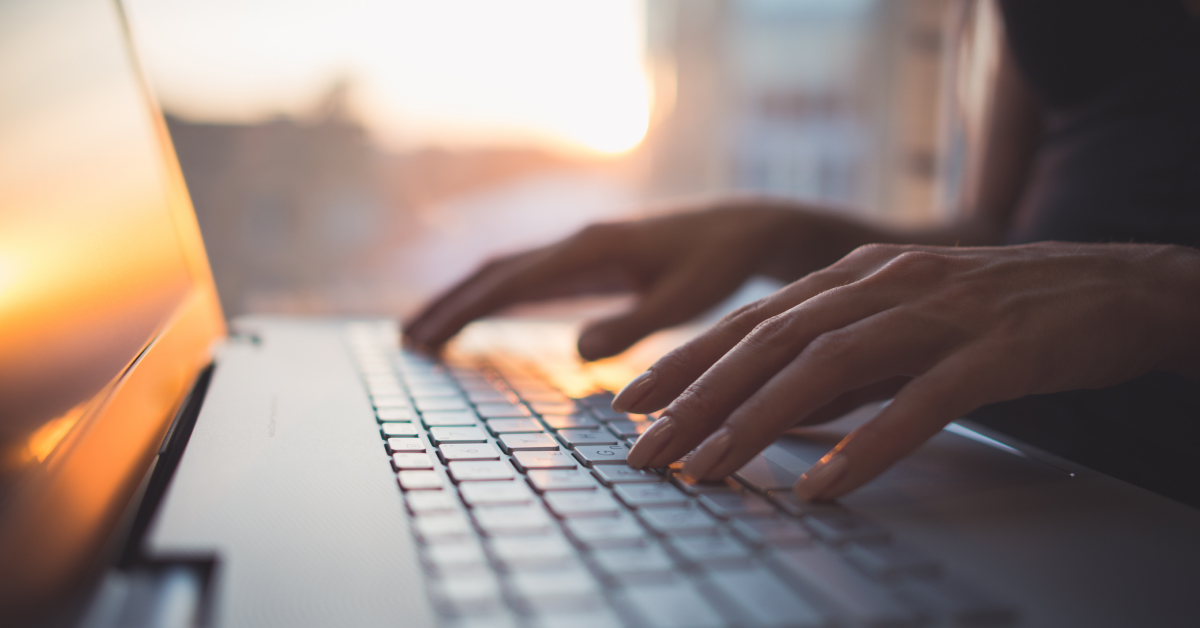 person typing on a laptop keyboard