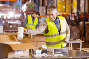 a man packing items in a warehouse