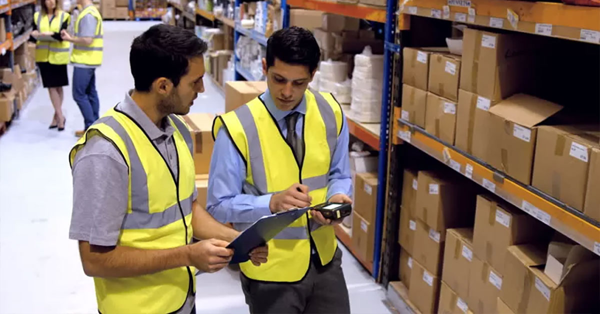 workers in a warehouse having a discussion