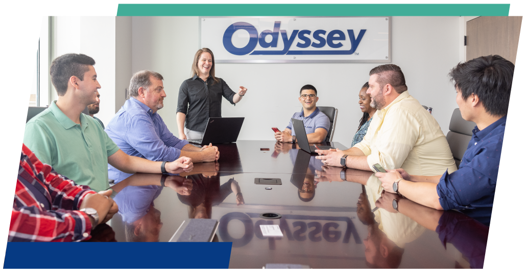 group of employees gathered around the conference table at the Odyssey office