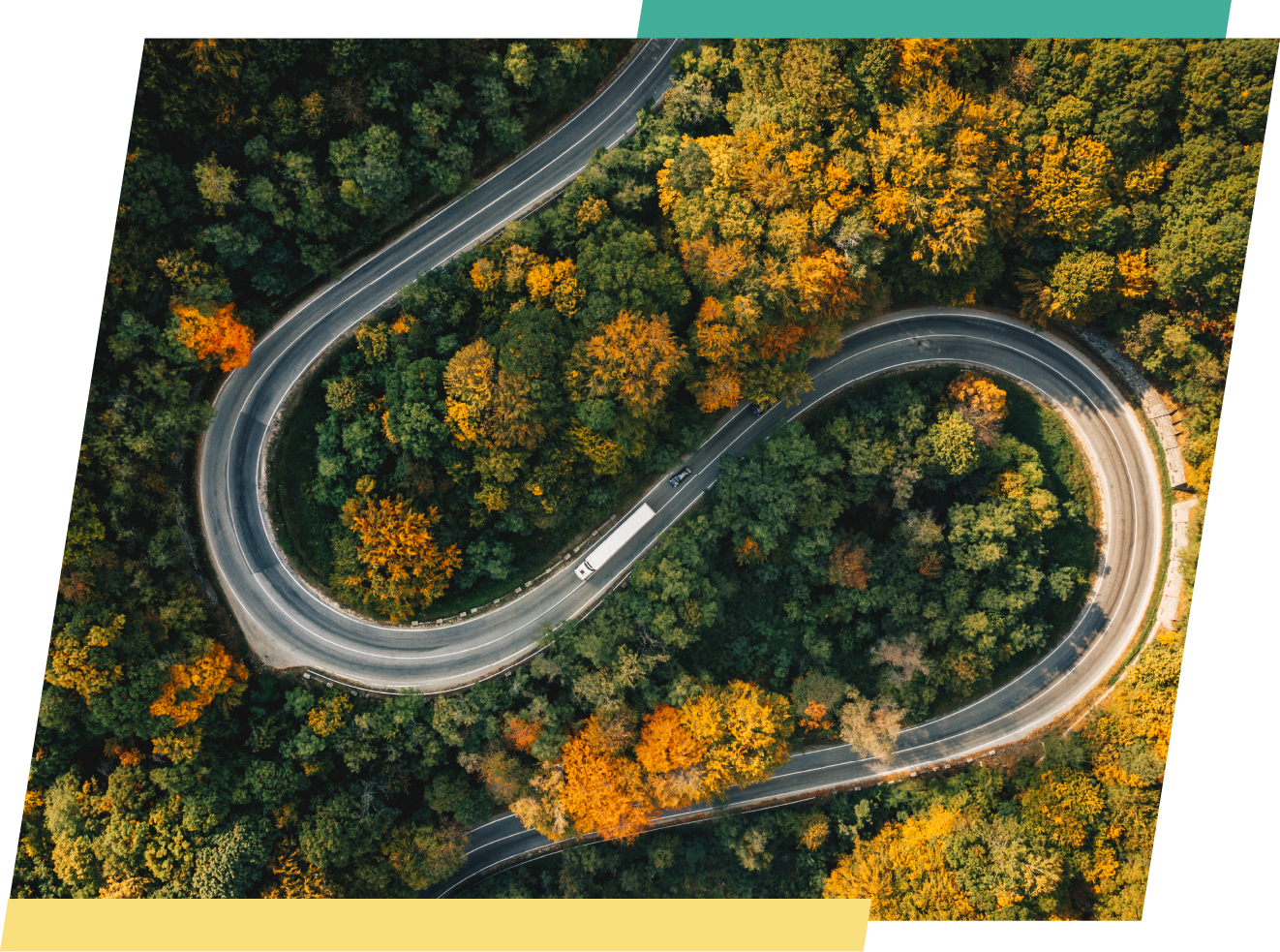 aerial view of a winding road in the fall with a semi truck driving