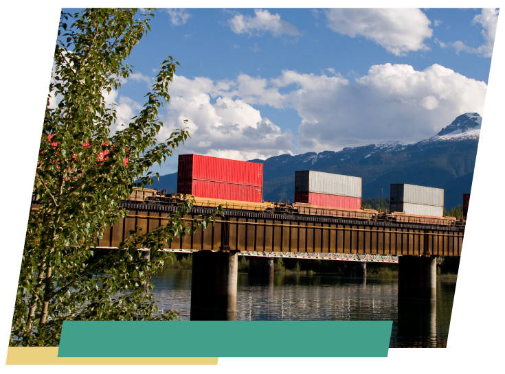 cargo containers loaded on a train going over a bridge