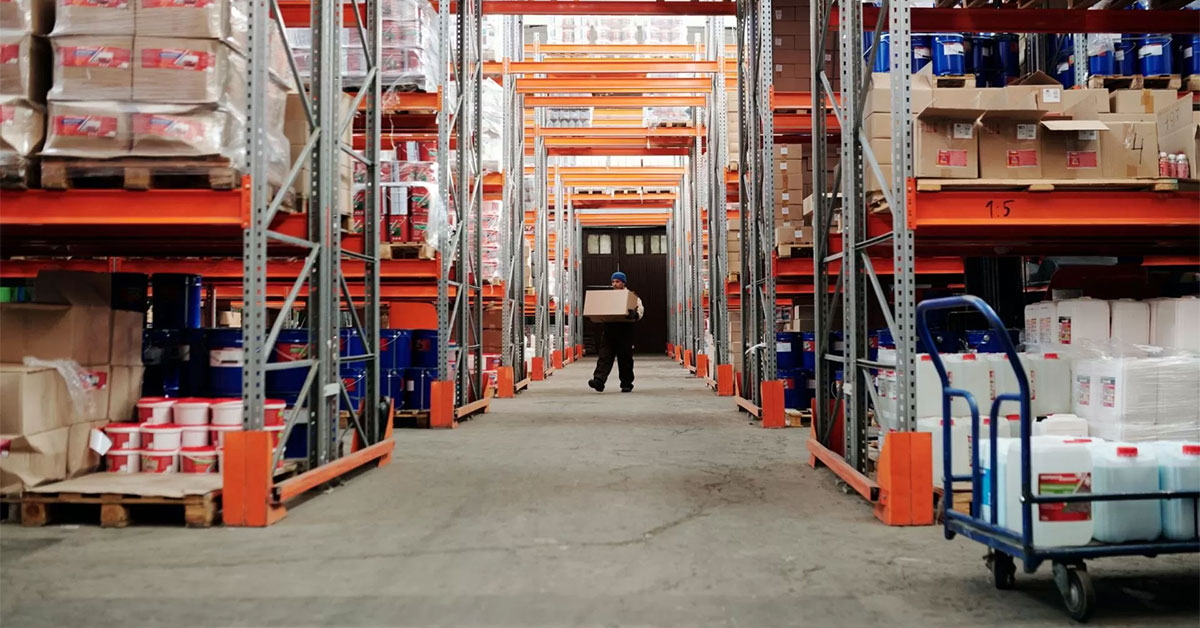 a person carrying a box through a warehouse