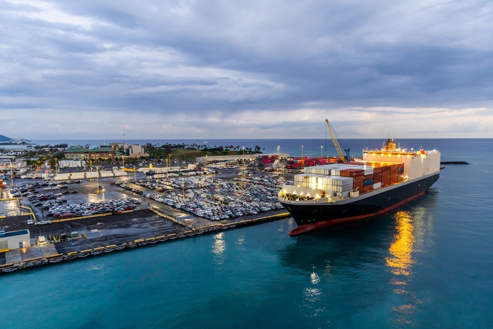 a ship in the water near a shipping port